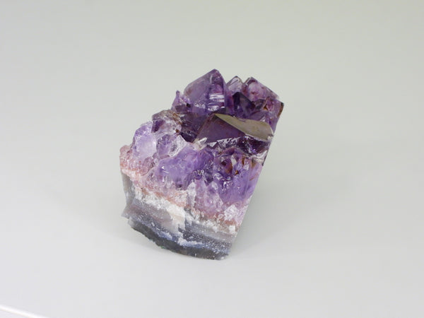 Beautiful Amethyst cluster with inclusions. Side view