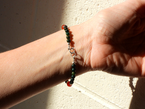 Carnelian, Peridot, Bloodstone and Moonstone Bracelet on someone's wrist