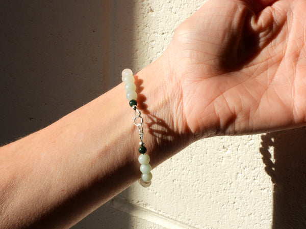 Bloodstone, Amazonite, Opalite and White Jade Bracelet on someone's wrist