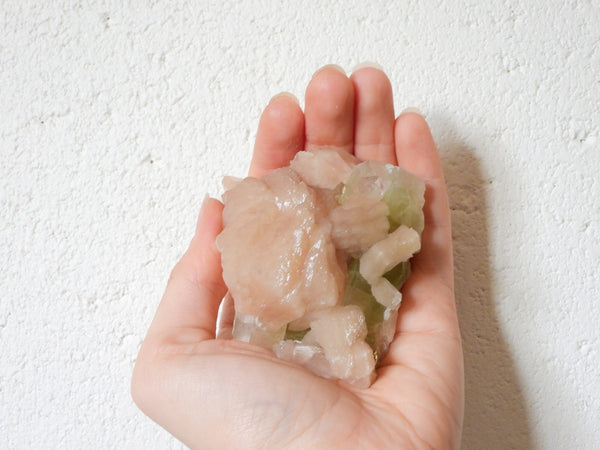 Green Apophyllite with Stilbite cluster in someone's hand