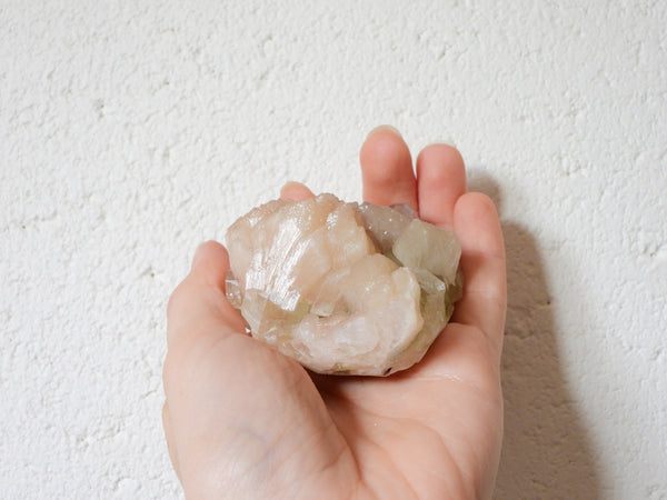 Green Apophyllite with Stilbite cluster in someone's hand