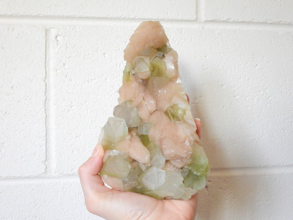 Green Apophyllite with Stilbite cluster in someone's hand