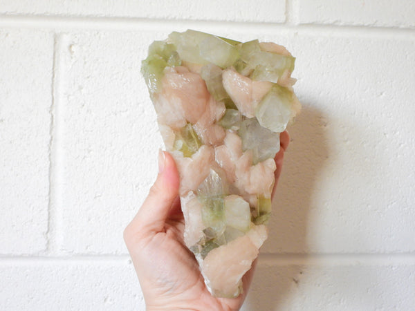 Green Apophyllite with Stilbite cluster in someone's hand