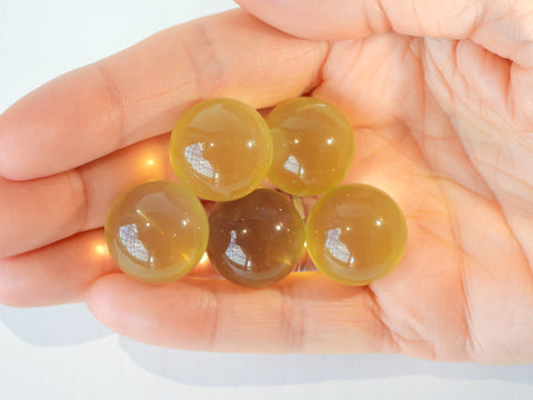 Multiple Star Citrine spheres in someone's hand, 8g size